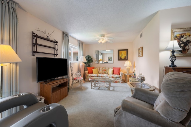 living room with ceiling fan, light colored carpet, and a textured ceiling