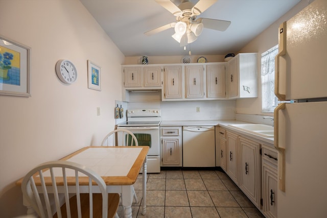kitchen featuring white appliances, light countertops, a sink, ceiling fan, and light tile patterned floors