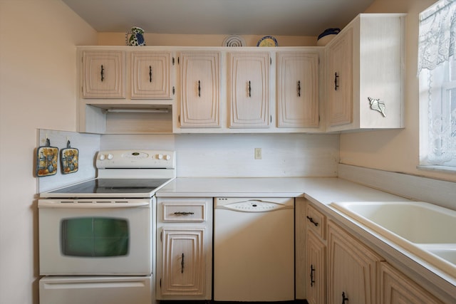 kitchen featuring white appliances, light countertops, backsplash, and a sink