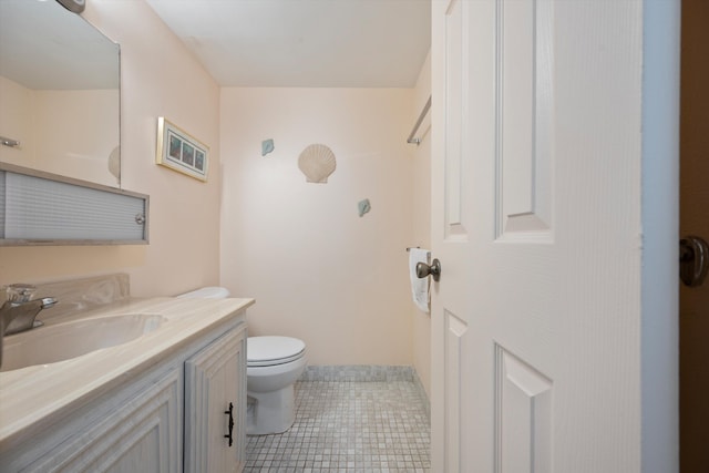 bathroom with vanity, toilet, and tile patterned floors