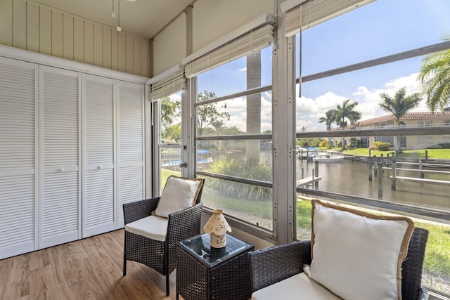 sunroom featuring a water view and healthy amount of natural light