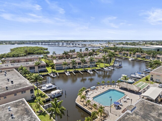 bird's eye view of a nearby body of water and a pool area