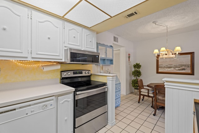 kitchen featuring appliances with stainless steel finishes, white cabinetry, a chandelier, light tile patterned floors, and a textured ceiling