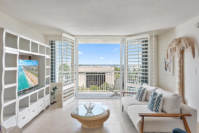 2780 S Ocean Blvd Unit 707, Palm Beach, FL 33480 - living area featuring a wall of windows, plenty of natural light, a textured ceiling, and tile patterned flooring