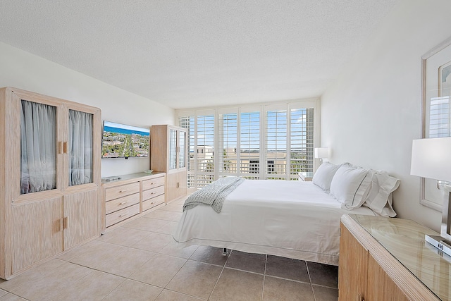 2780 S Ocean Blvd Unit 707, Palm Beach, FL 33480 - bedroom with light tile patterned floors and a textured ceiling