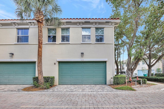 4128 Cascada Cir, Cooper City, FL 33024 - townhome / multi-family property with a garage, stucco siding, and decorative driveway