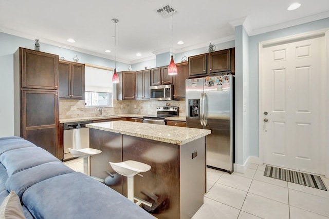 4128 Cascada Cir, Cooper City, FL 33024 - kitchen featuring stainless steel appliances, ornamental molding, open floor plan, tasteful backsplash, and light tile patterned flooring