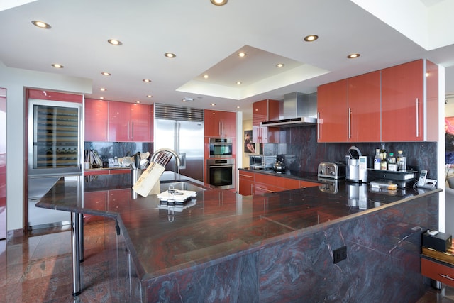 529 S Flagler Dr Unit 26H, West Palm Beach, FL 33401 - kitchen with recessed lighting, wall chimney exhaust hood, appliances with stainless steel finishes, a sink, and tasteful backsplash
