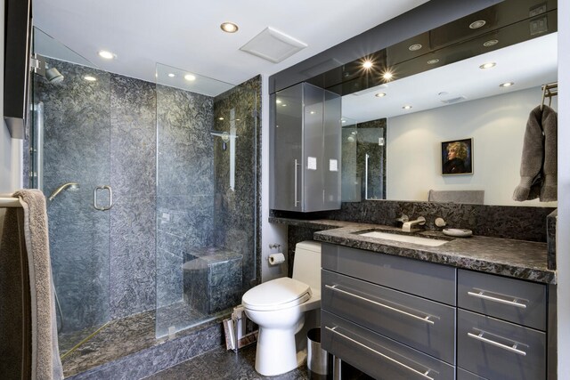 529 S Flagler Dr Unit 26H, West Palm Beach, FL 33401 - bathroom with toilet, a shower stall, vanity, and recessed lighting