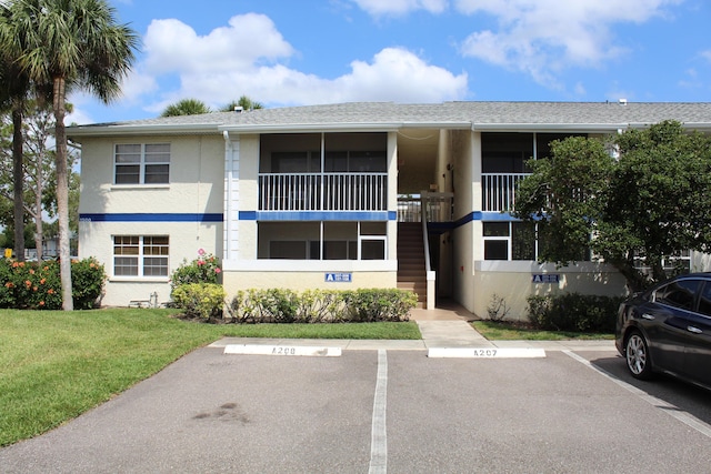 1500 SE Royal Green Cir Unit 208, Port Saint Lucie, FL 34952 - view of building exterior featuring uncovered parking and stairway