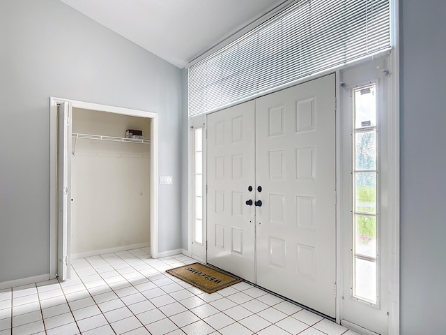 entrance foyer featuring light tile patterned floors and baseboards
