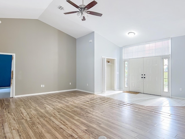entryway featuring vaulted ceiling, light wood finished floors, a ceiling fan, and baseboards