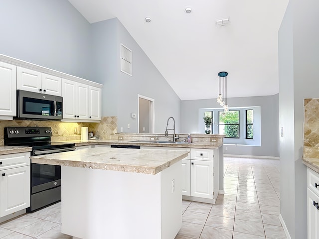 kitchen featuring appliances with stainless steel finishes, a sink, a peninsula, light countertops, and a kitchen island
