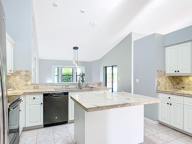 kitchen featuring dishwasher, black range with electric stovetop, a sink, a peninsula, and light countertops