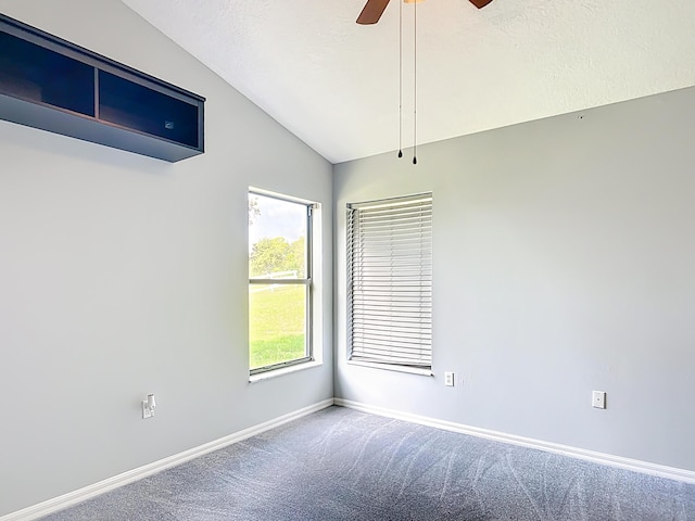carpeted spare room with lofted ceiling, baseboards, and ceiling fan