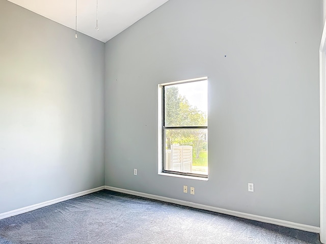 carpeted spare room with baseboards