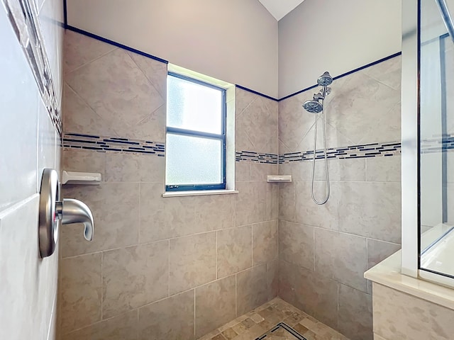 bathroom featuring a tile shower