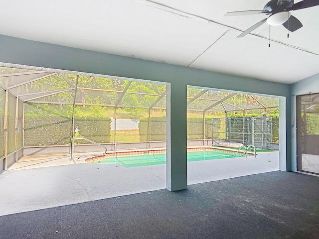 outdoor pool with a patio, ceiling fan, and a lanai