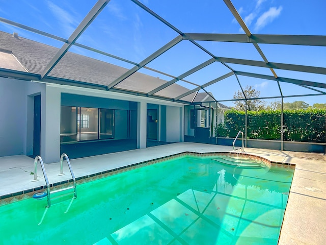 outdoor pool with a patio and glass enclosure