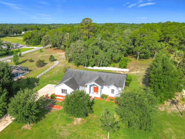 aerial view of property and surrounding area with a forest