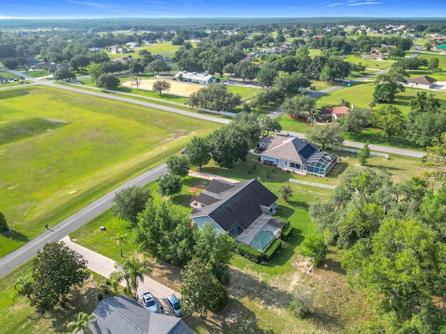 aerial view of property and surrounding area featuring nearby suburban area