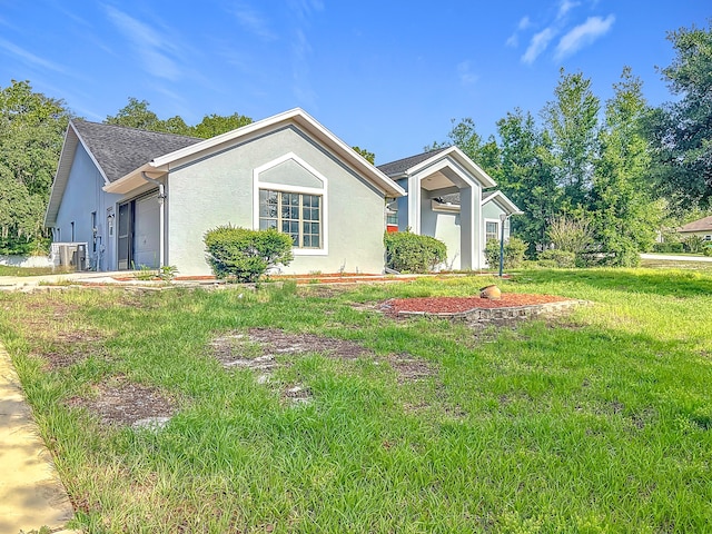 single story home with stucco siding, an attached garage, and a front yard