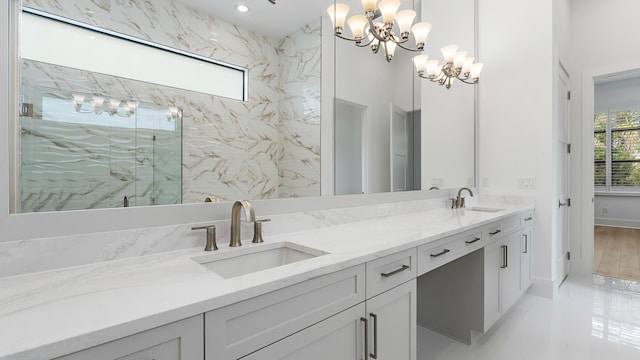 13250 Artisan Cir, Palm Beach Gardens, FL 33418 - bathroom featuring double vanity, a marble finish shower, and a chandelier