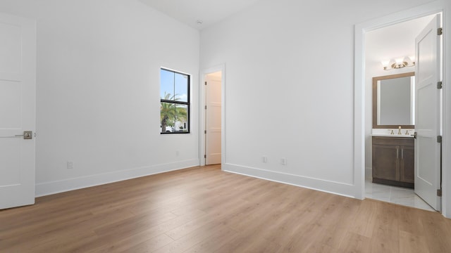13250 Artisan Cir, Palm Beach Gardens, FL 33418 - unfurnished bedroom featuring light wood-style floors and ensuite bathroom