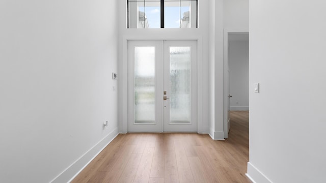 13250 Artisan Cir, Palm Beach Gardens, FL 33418 - foyer entrance with french doors, wood finished floors, and a towering ceiling