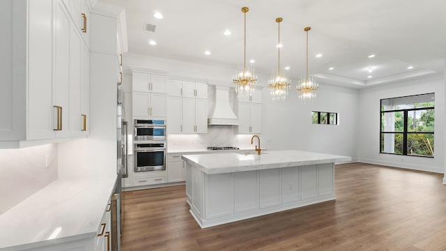 13250 Artisan Cir, Palm Beach Gardens, FL 33418 - kitchen with premium range hood, dark wood-style floors, a chandelier, white cabinets, and recessed lighting