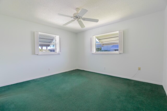 631 SW 21st Cir, Boynton Beach, FL 33426 - spare room with healthy amount of natural light, dark carpet, baseboards, and a textured ceiling