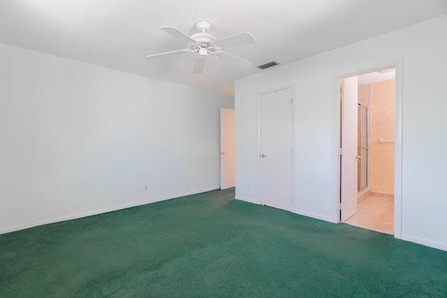 631 SW 21st Cir, Boynton Beach, FL 33426 - unfurnished bedroom with carpet, ensuite bath, baseboards, and a ceiling fan