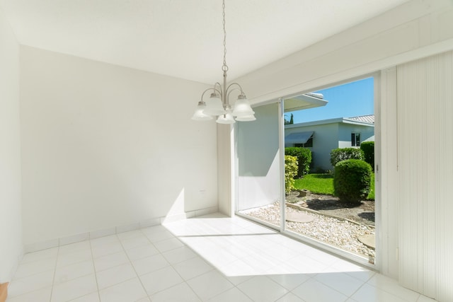 unfurnished dining area with a chandelier