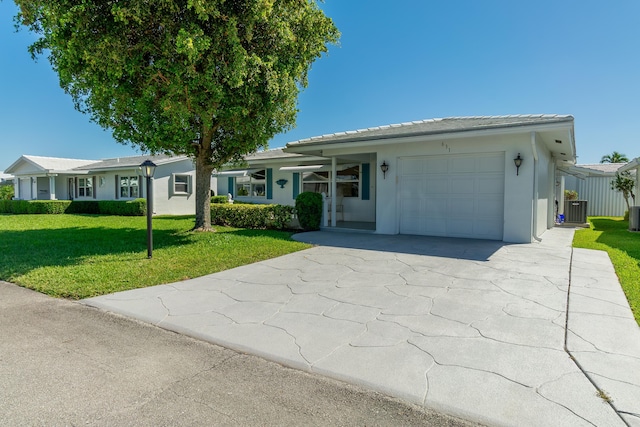 631 SW 21st Cir, Boynton Beach, FL 33426 - ranch-style home featuring an attached garage, central AC unit, a front lawn, concrete driveway, and stucco siding