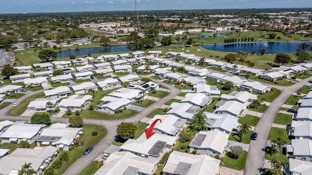 aerial view of property and surrounding area with nearby suburban area and a nearby body of water