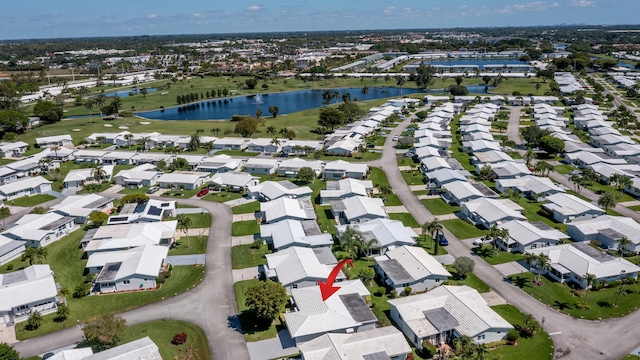 aerial view of property and surrounding area featuring a large body of water and nearby suburban area
