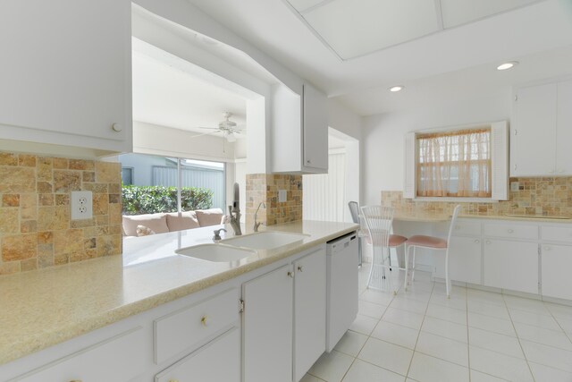 631 SW 21st Cir, Boynton Beach, FL 33426 - kitchen with dishwasher, a sink, decorative backsplash, light countertops, and light tile patterned flooring