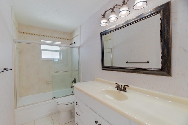full bathroom with toilet, vanity, shower / bath combination with glass door, tile patterned flooring, and a textured ceiling