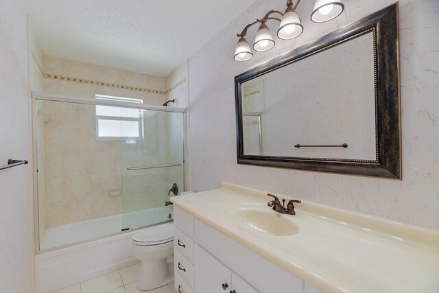 631 SW 21st Cir, Boynton Beach, FL 33426 - full bathroom featuring toilet, vanity, enclosed tub / shower combo, tile patterned flooring, and a textured ceiling