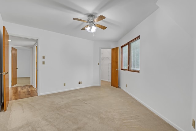 1130 Melinda Ln, Haverhill, FL 33417 - unfurnished bedroom featuring carpet, baseboards, a spacious closet, and a ceiling fan