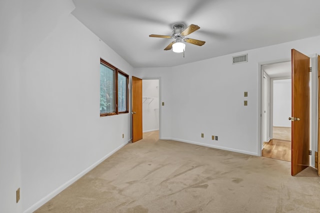 1130 Melinda Ln, Haverhill, FL 33417 - unfurnished bedroom featuring light colored carpet, baseboards, ceiling fan, and a spacious closet