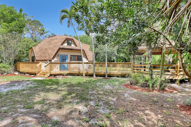 1130 Melinda Ln, Haverhill, FL 33417 - rear view of property featuring a deck and roof with shingles