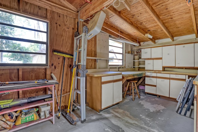 1130 Melinda Ln, Haverhill, FL 33417 - miscellaneous room with concrete floors, a workshop area, and wood walls