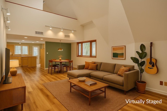 1130 Melinda Ln, Haverhill, FL 33417 - living area with light wood finished floors, rail lighting, baseboards, high vaulted ceiling, and recessed lighting