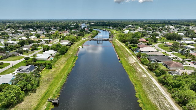 472 SW Aster Rd, Port Saint Lucie, FL 34953 - aerial overview of property's location with a nearby body of water and nearby suburban area