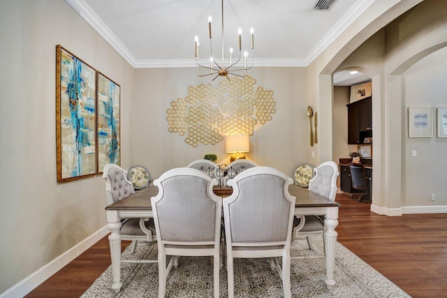 11354 Mainsail Ct, Wellington, FL 33449 - dining room with a chandelier, arched walkways, wood finished floors, ornamental molding, and baseboards