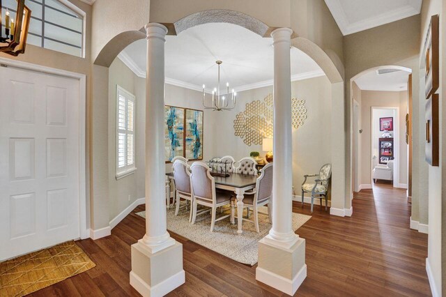11354 Mainsail Ct, Wellington, FL 33449 - entryway featuring arched walkways, ornamental molding, wood finished floors, baseboards, and a chandelier