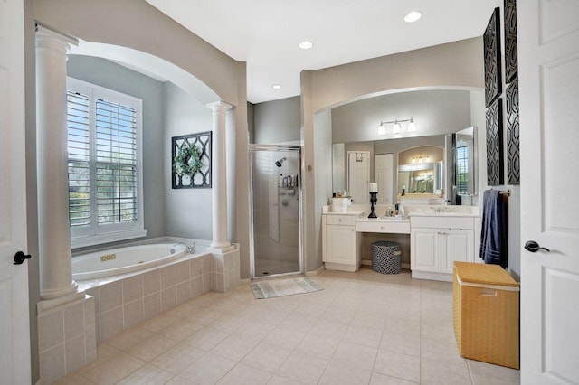 11354 Mainsail Ct, Wellington, FL 33449 - full bath featuring ornate columns, vanity, a garden tub, a shower stall, and tile patterned floors