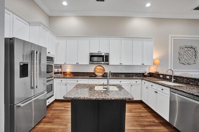11354 Mainsail Ct, Wellington, FL 33449 - kitchen featuring stainless steel appliances, a sink, ornamental molding, dark stone counters, and white cabinetry