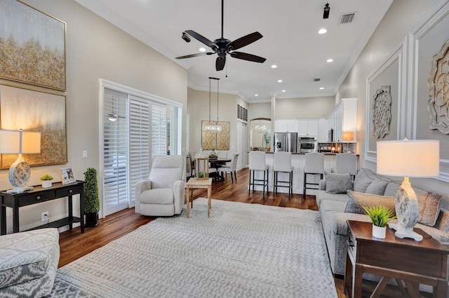 11354 Mainsail Ct, Wellington, FL 33449 - living room featuring dark wood finished floors, ceiling fan, a chandelier, ornamental molding, and recessed lighting
